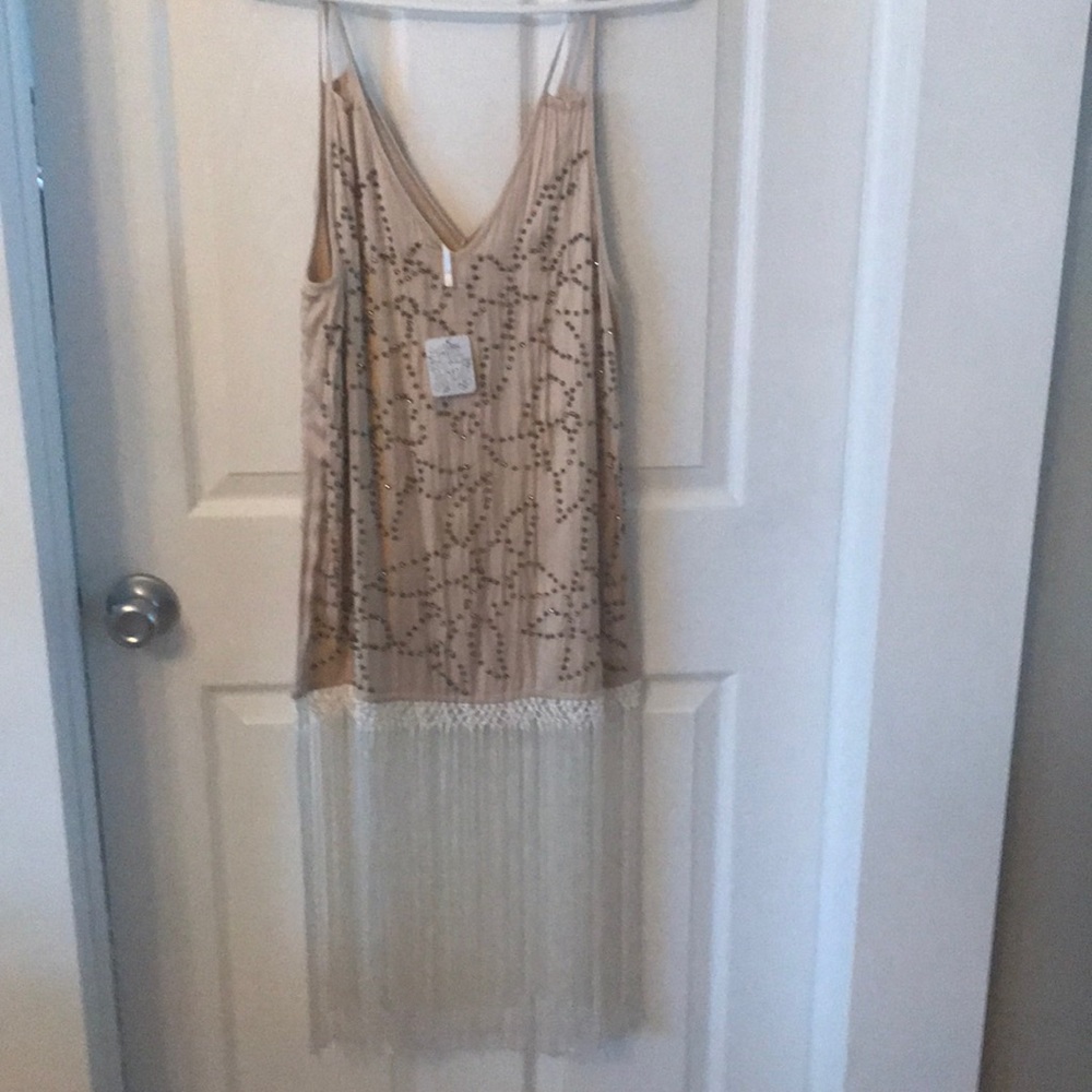 Beautiful silk top with rhinestones and fringe.
